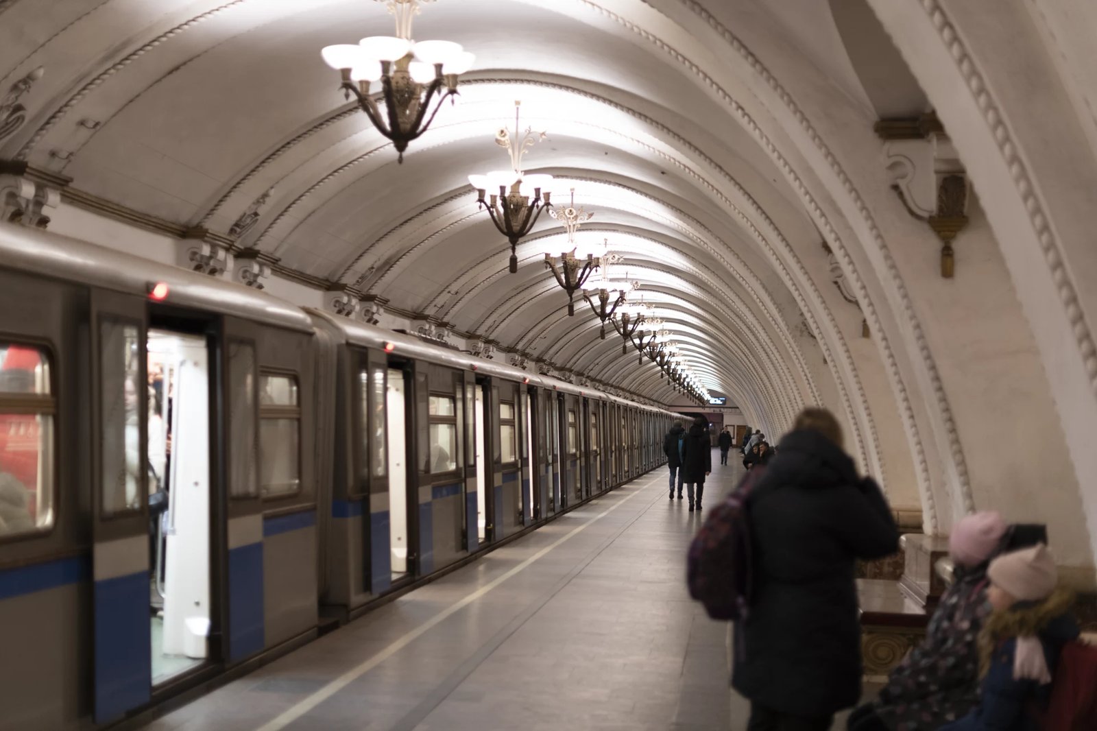 Arbatskaya platform with a train and ornate chandeliers